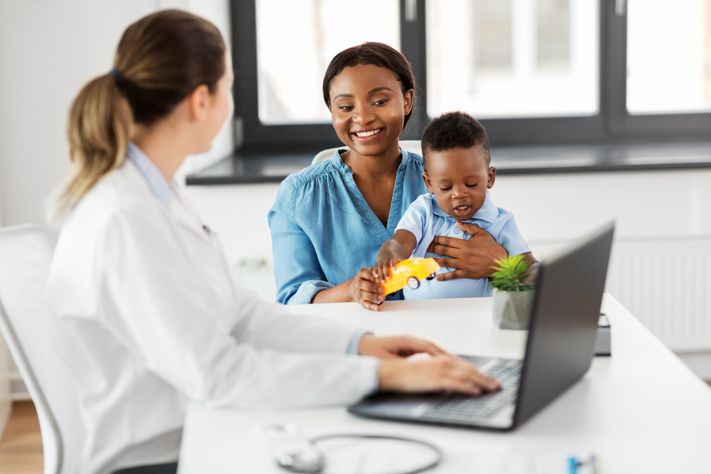 Mother and Son Consulting with Pediatrician 